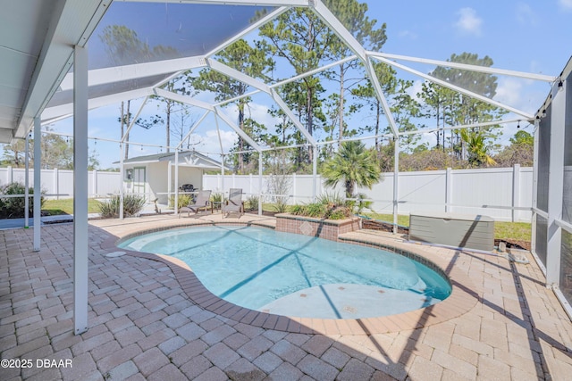 view of pool with a fenced in pool, a lanai, a fenced backyard, an outbuilding, and a patio