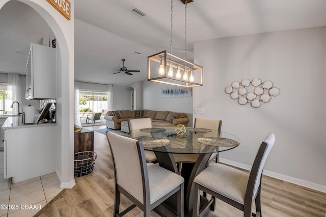 dining area with light wood-type flooring, visible vents, plenty of natural light, and a ceiling fan