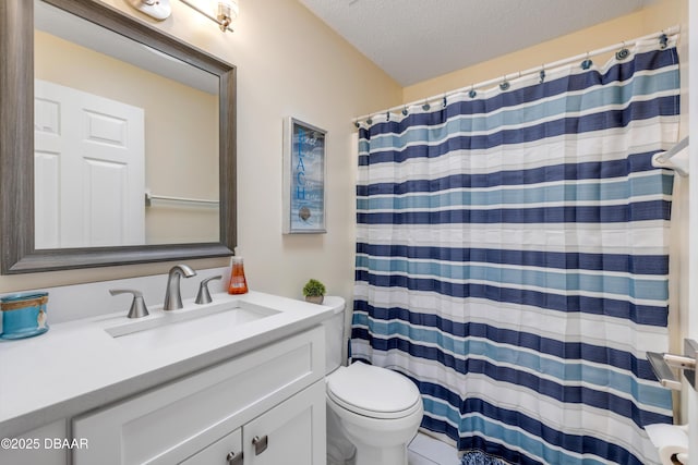 bathroom with vanity, toilet, a shower with curtain, and a textured ceiling