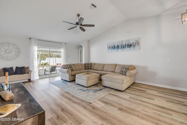 living room with visible vents, a ceiling fan, wood finished floors, arched walkways, and lofted ceiling