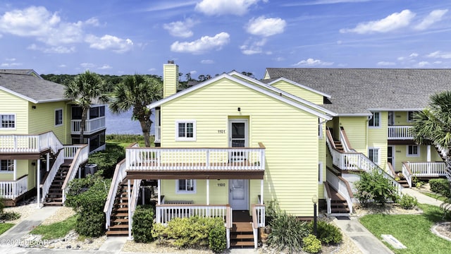 1101 Ocean Marina Dr Unit 201, Flagler Beach, FL 32136 - view of front of house featuring stairway, a chimney, and a porch