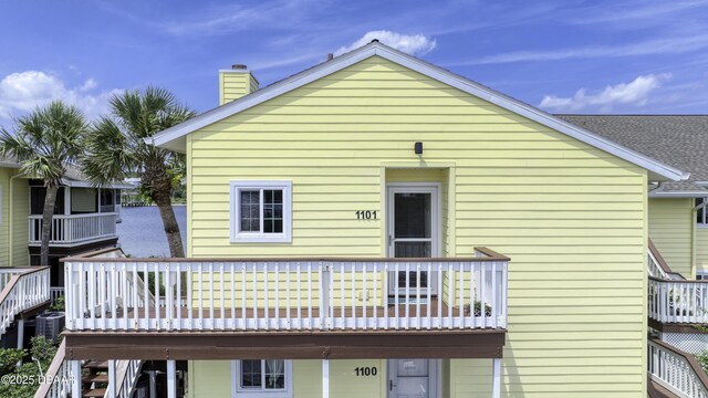 1101 Ocean Marina Dr Unit 201, Flagler Beach, FL 32136 - rear view of property featuring a chimney and cooling unit