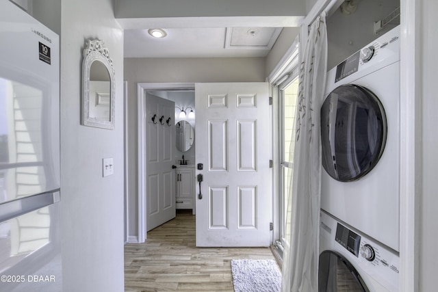 1101 Ocean Marina Dr Unit 201, Flagler Beach, FL 32136 - washroom featuring stacked washer / dryer and light wood finished floors