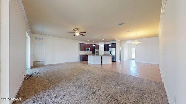 unfurnished living room with light tile patterned floors, visible vents, light carpet, baseboards, and ceiling fan with notable chandelier