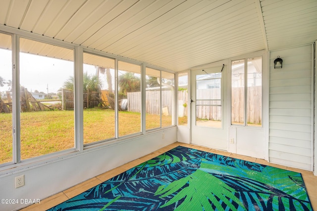 unfurnished sunroom with lofted ceiling