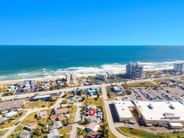 drone / aerial view with a beach view and a water view