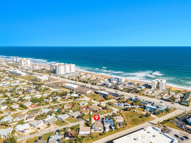 birds eye view of property featuring a beach view and a water view