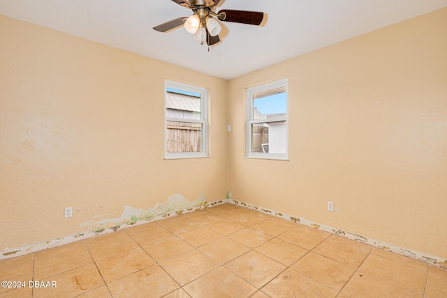 spare room with ceiling fan and tile patterned flooring