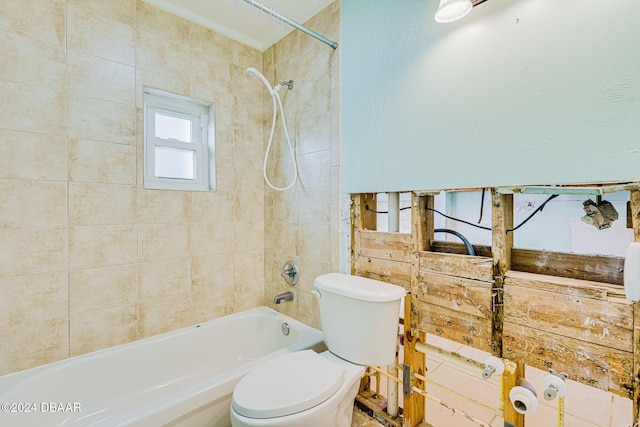 bathroom featuring crown molding, toilet, and tiled shower / bath