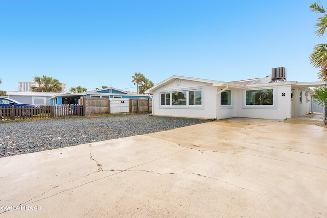 view of front of home with central AC unit and a patio area