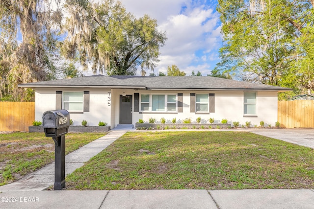 ranch-style home with a front yard