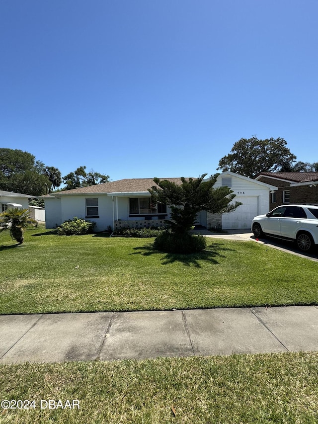 view of front of property with a garage and a front yard