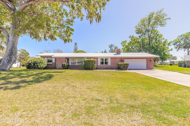 ranch-style house with brick siding, a front lawn, a chimney, driveway, and an attached garage