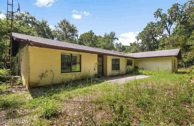 21305 86th Ave, Micanopy, FL 32667 - back of house with a patio area and stucco siding