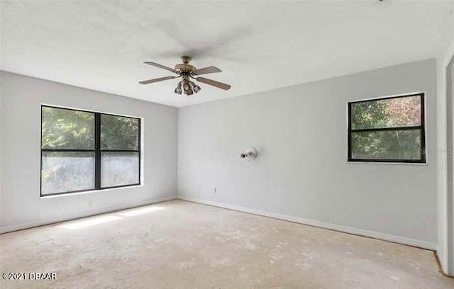 empty room with a wealth of natural light and ceiling fan