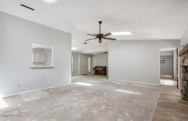 21305 86th Ave, Micanopy, FL 32667 - unfurnished living room featuring a ceiling fan and vaulted ceiling