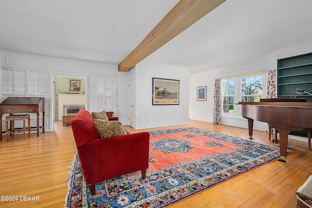 living room featuring beamed ceiling and wood-type flooring