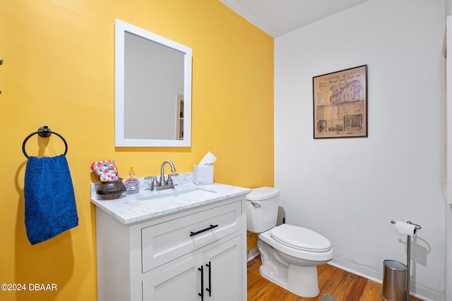 bathroom featuring hardwood / wood-style flooring, vanity, and toilet