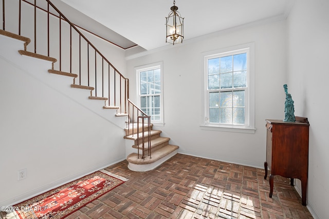 stairs featuring a chandelier, parquet floors, and ornamental molding