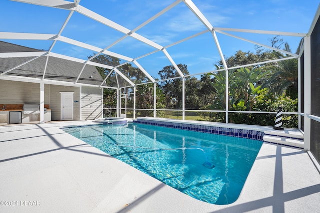 view of swimming pool with a lanai and a patio area