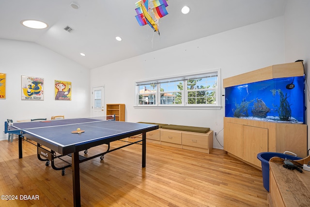 playroom featuring light wood-type flooring and lofted ceiling