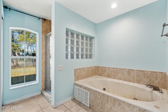 bathroom featuring tile patterned floors and shower with separate bathtub