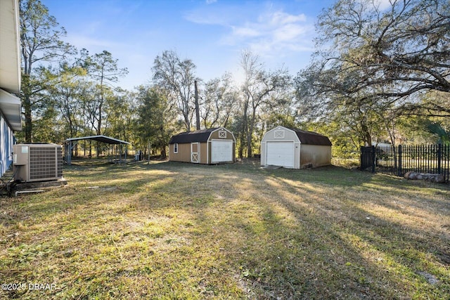 view of yard featuring an outbuilding, cooling unit, and a carport