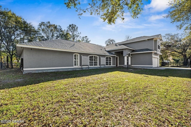 view of front facade with a garage and a front lawn