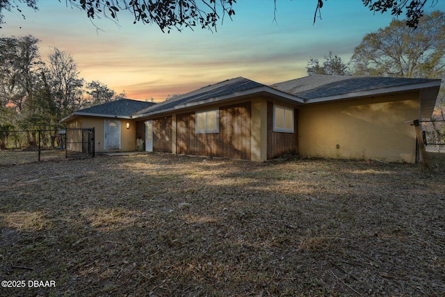 view of back house at dusk