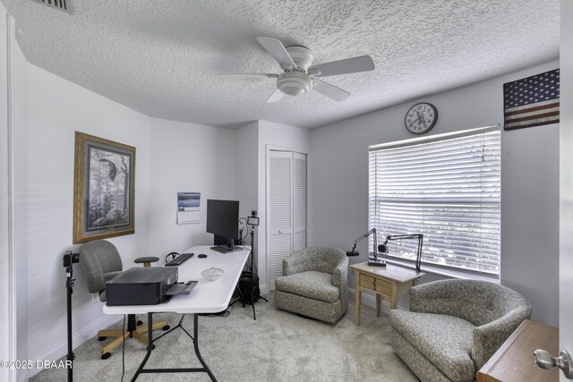 office featuring carpet floors, a textured ceiling, ceiling fan, and baseboards
