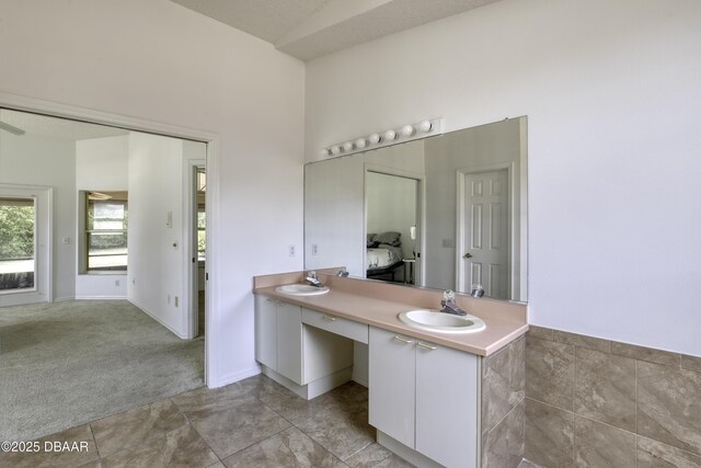 full bath featuring double vanity and a sink