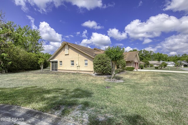 view of property exterior featuring stucco siding and a yard