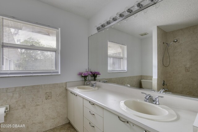 bathroom featuring plenty of natural light, a sink, and toilet