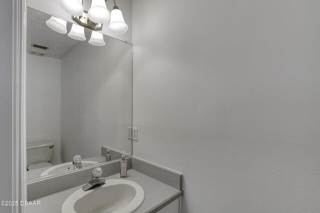 half bath featuring toilet and vanity