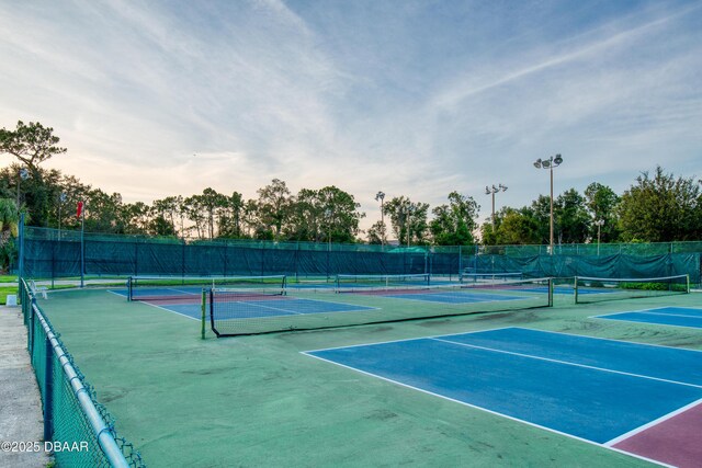 view of tennis court featuring fence