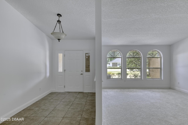 entrance foyer featuring baseboards and a textured ceiling