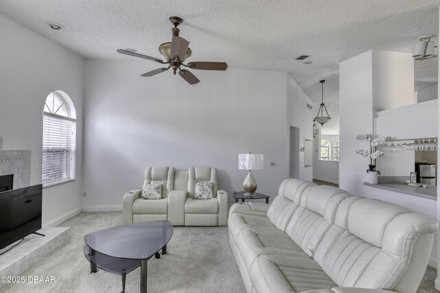 carpeted living area with a textured ceiling, ceiling fan, lofted ceiling, and a wealth of natural light