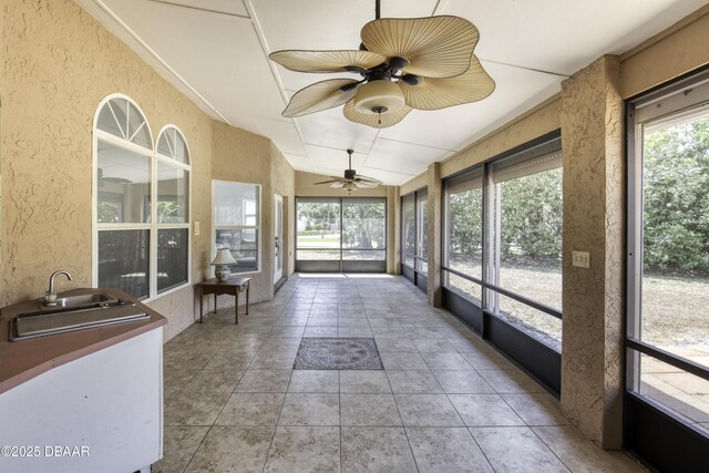 sunroom with a sink and ceiling fan