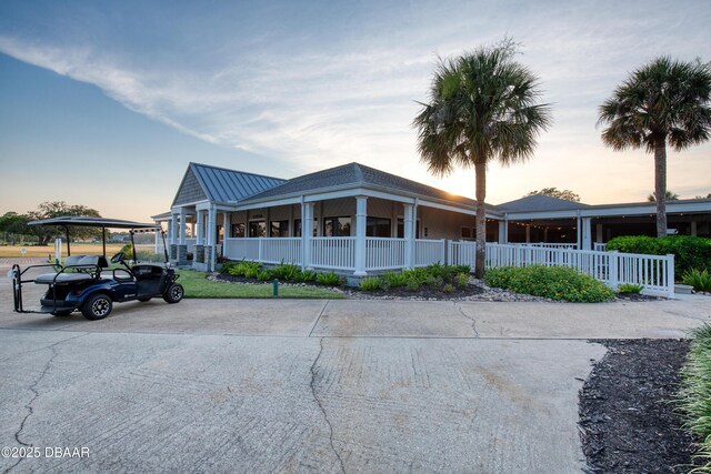 view of front of property with a porch, a standing seam roof, and metal roof