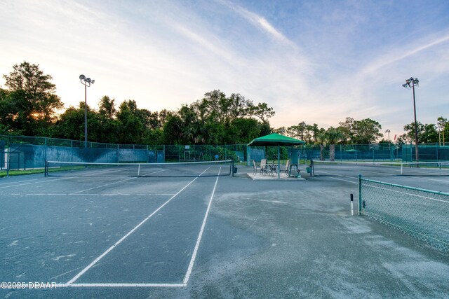 view of tennis court featuring fence