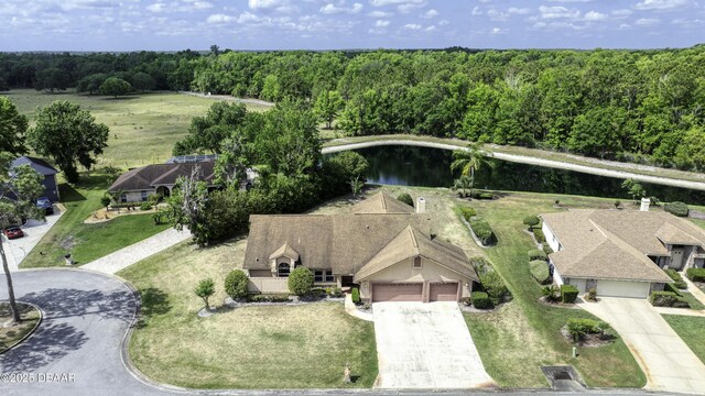 birds eye view of property with a view of trees