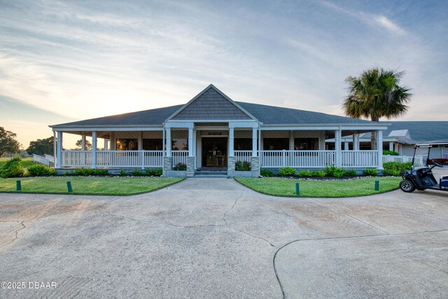 farmhouse with covered porch and a yard