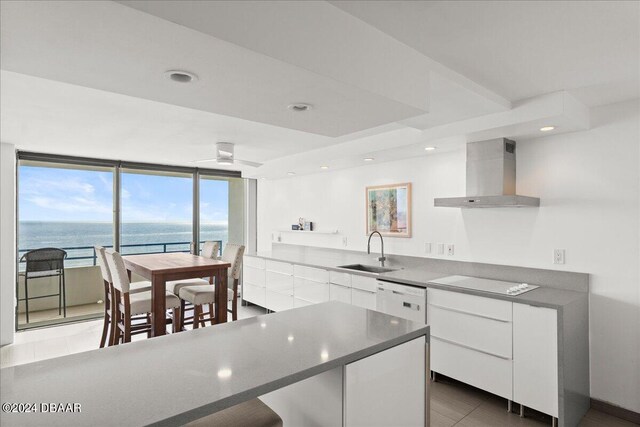 living room featuring a wall of windows, a view of the beach, and a water view