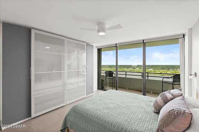 bedroom featuring access to outside, floor to ceiling windows, and ceiling fan