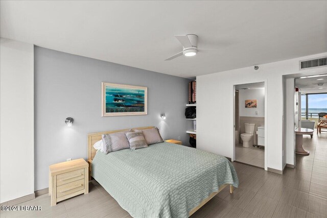 bedroom with ensuite bath and ceiling fan