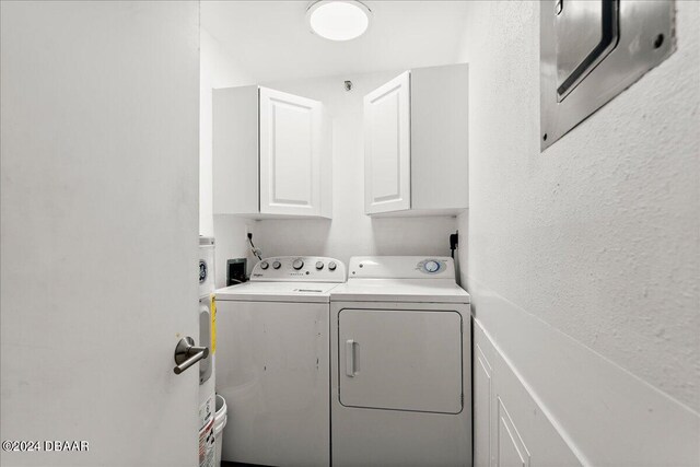 laundry room with cabinets and washer and dryer