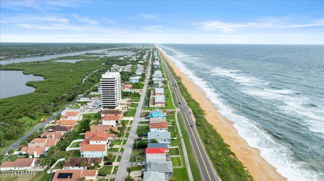 birds eye view of property with a view of the beach and a water view