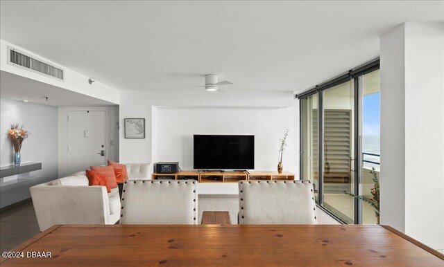 living room with ceiling fan and floor to ceiling windows