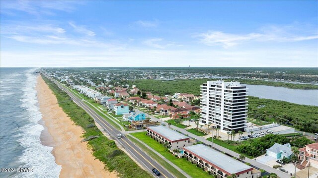 drone / aerial view with a beach view and a water view