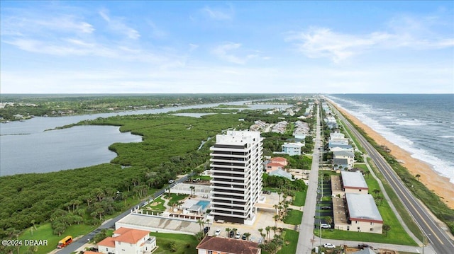 drone / aerial view featuring a beach view and a water view